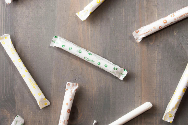 Multiple paper straws with printed designs on a wooden surface