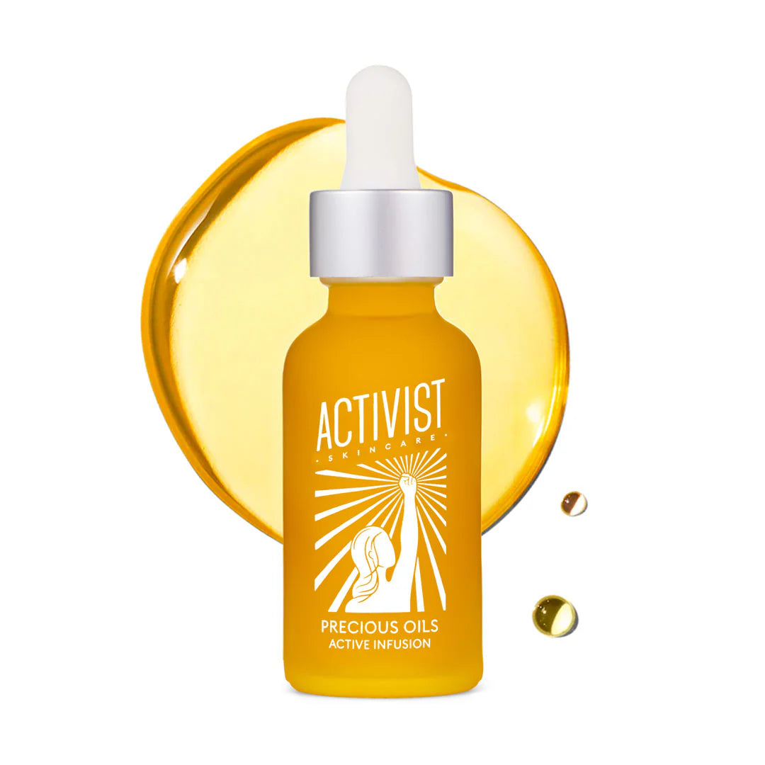 A dropper bottle of Precious Oils Active Infusion face oil with a yellow tinted background and a cucumber graphic illustration.