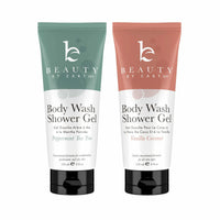 Two tubes of Beauty by Earth body wash in different colors, one green and one pink, with the product name and description printed on the labels.