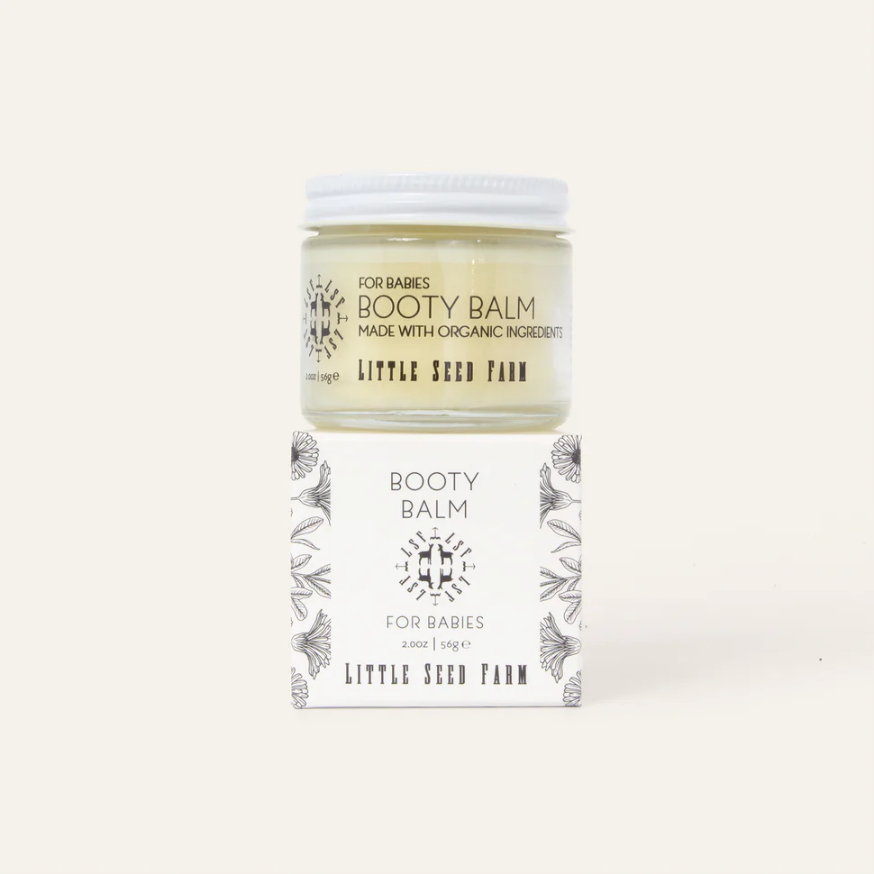Booty balm jar with packaging on a white background