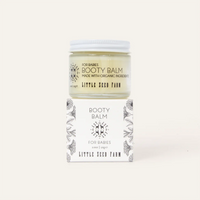 Booty balm jar with packaging on a white background