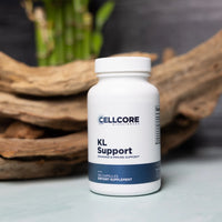 A white bottle labeled 'KL Support' by Cellcore Biotech, intended for dietary supplement, displayed against a backdrop with a wooden element.