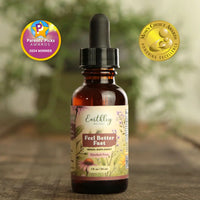 Bottle of Earthly Health supplement with awards on a wooden surface