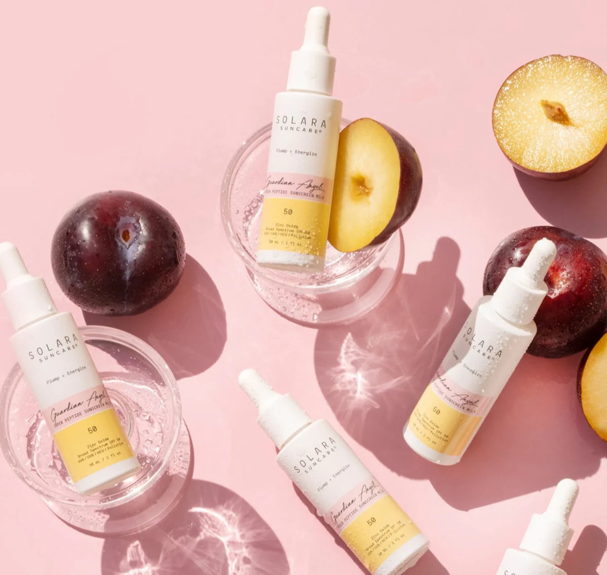 A bundle of Solara Suncare dropper bottles displayed on a light pink background. 