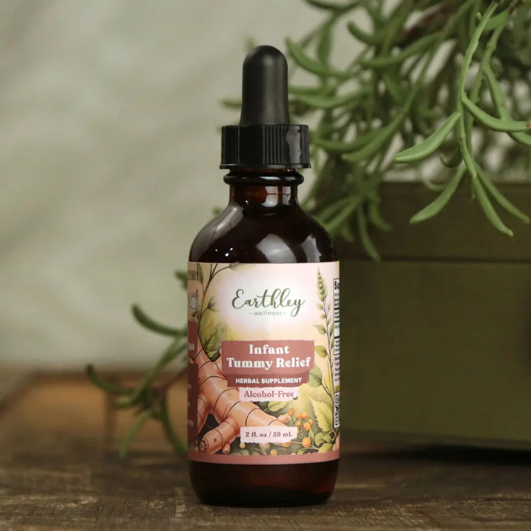 Bottle of Earthley Naturals Infant Tummy Relief supplement with a plant in the background
