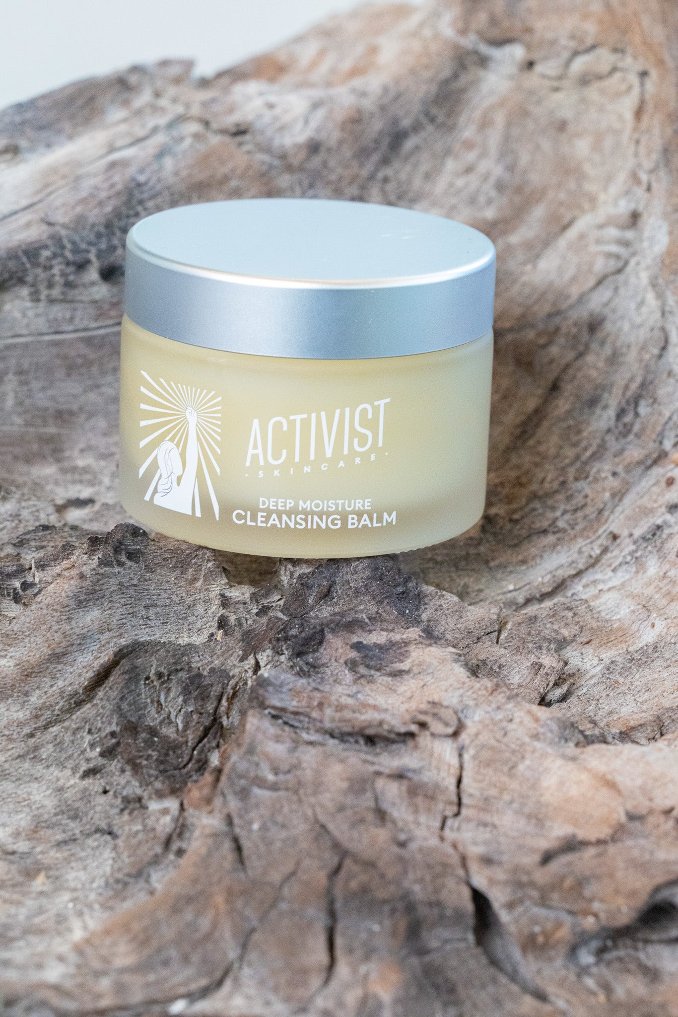 Activist Cleansing balm jar on driftwood