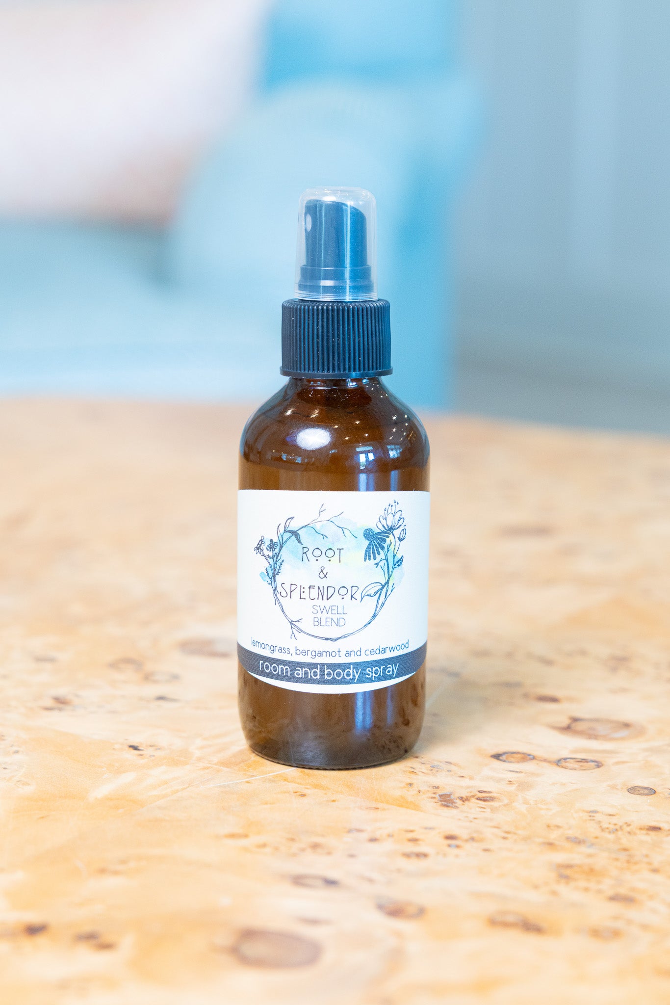 Bottle of body spray on a wooden surface with a blurred background