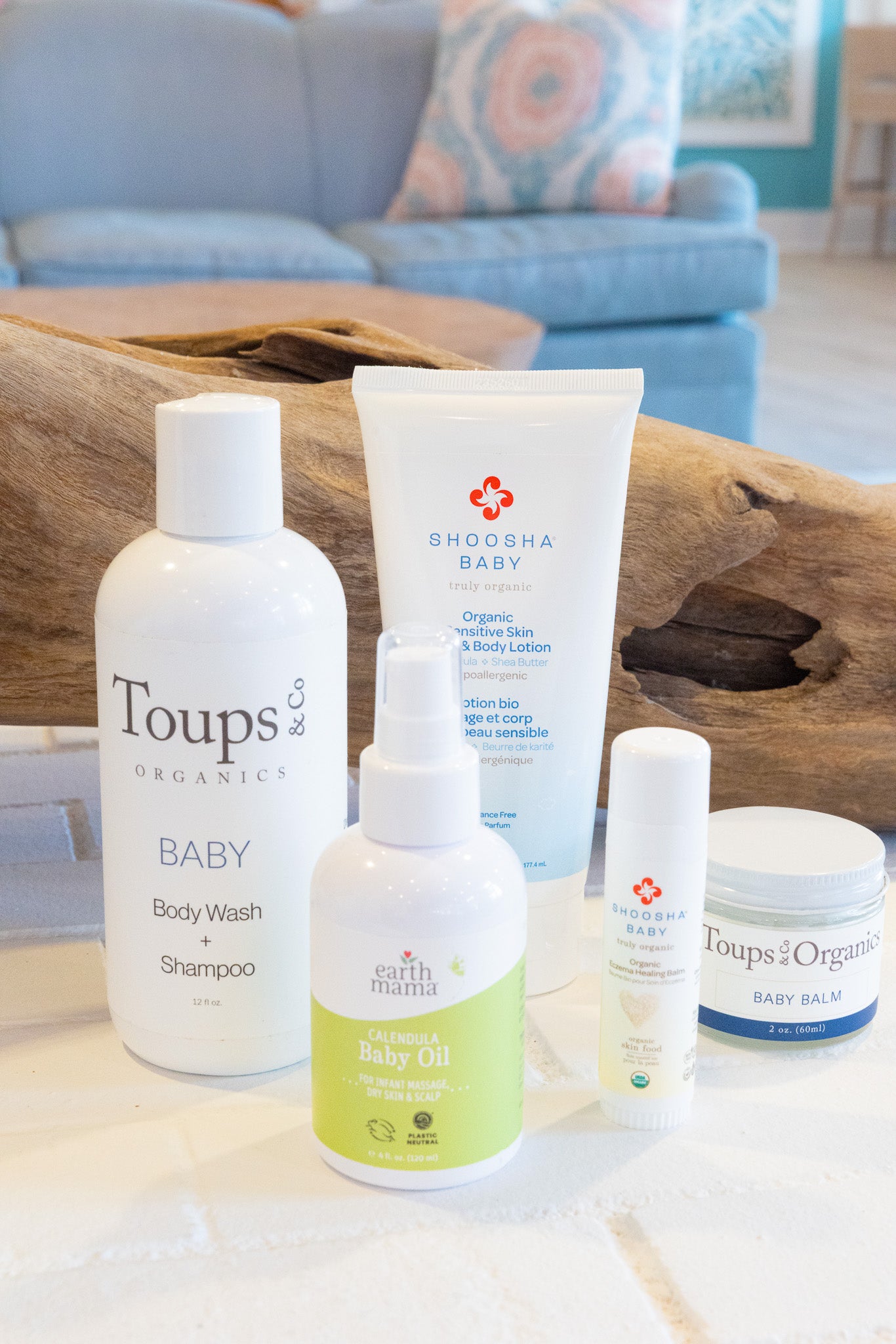 Collection of baby care products on a wooden surface with a blurred background