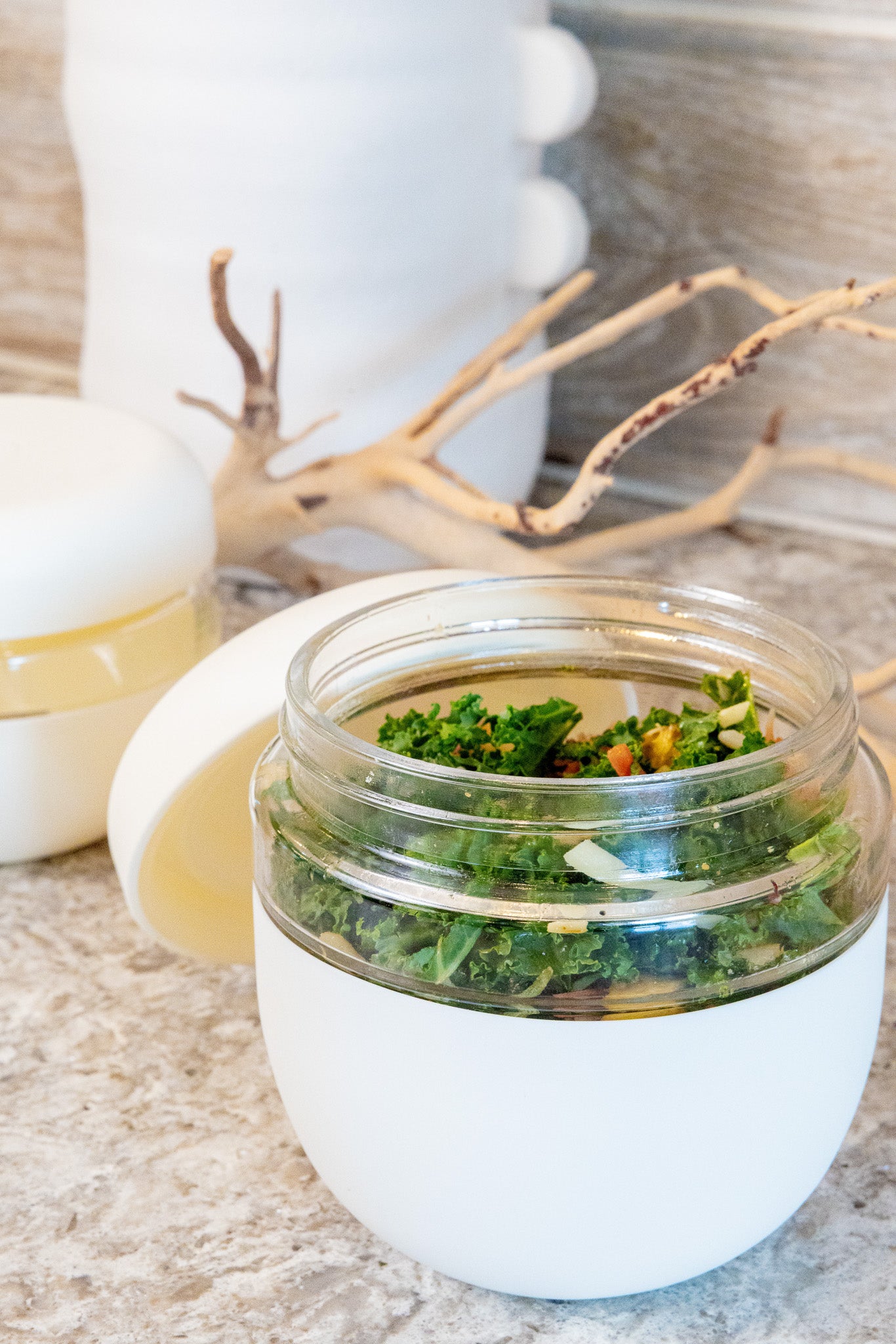 Glass jar with salad on a marble surface