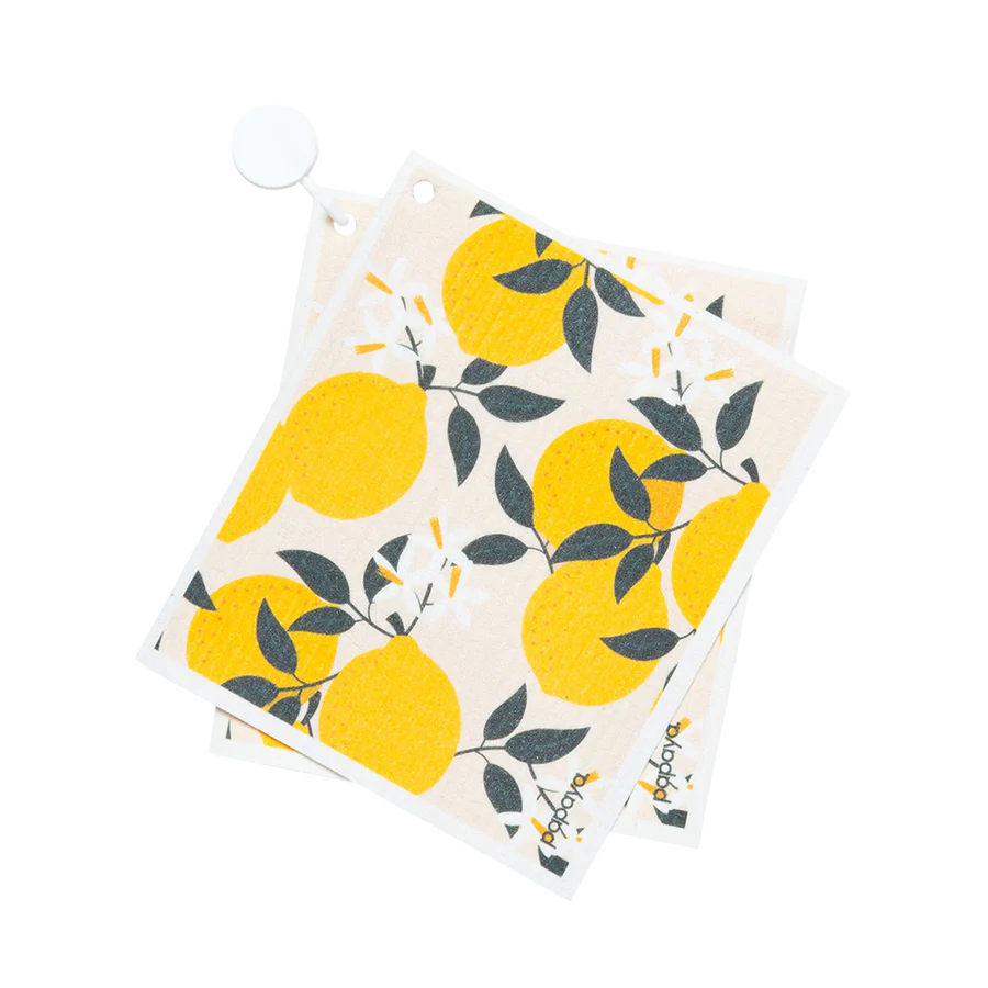 A reusable paper towel with a yellow lemon print design, hanging on a hook.