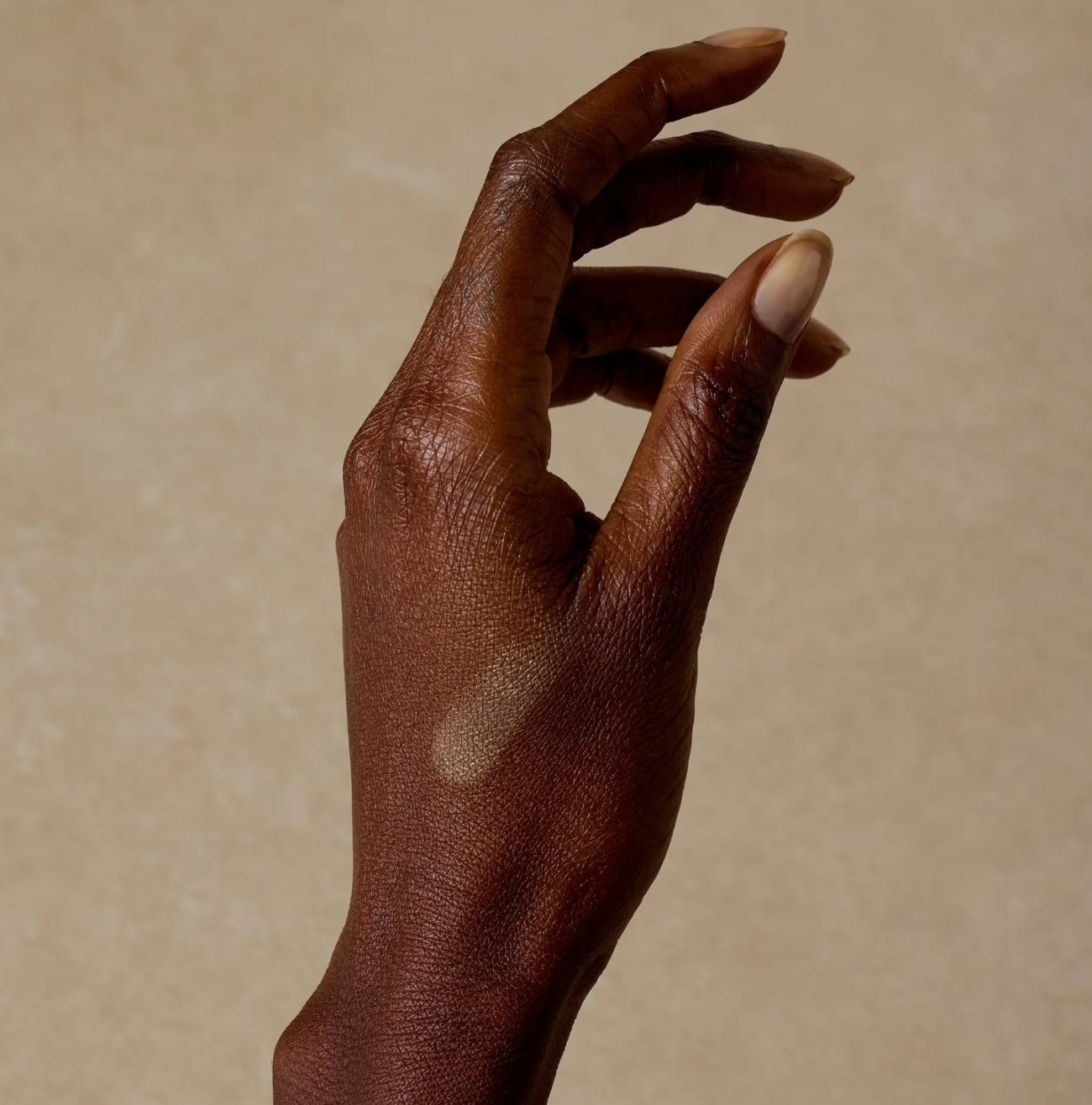 balm on dark brown hand