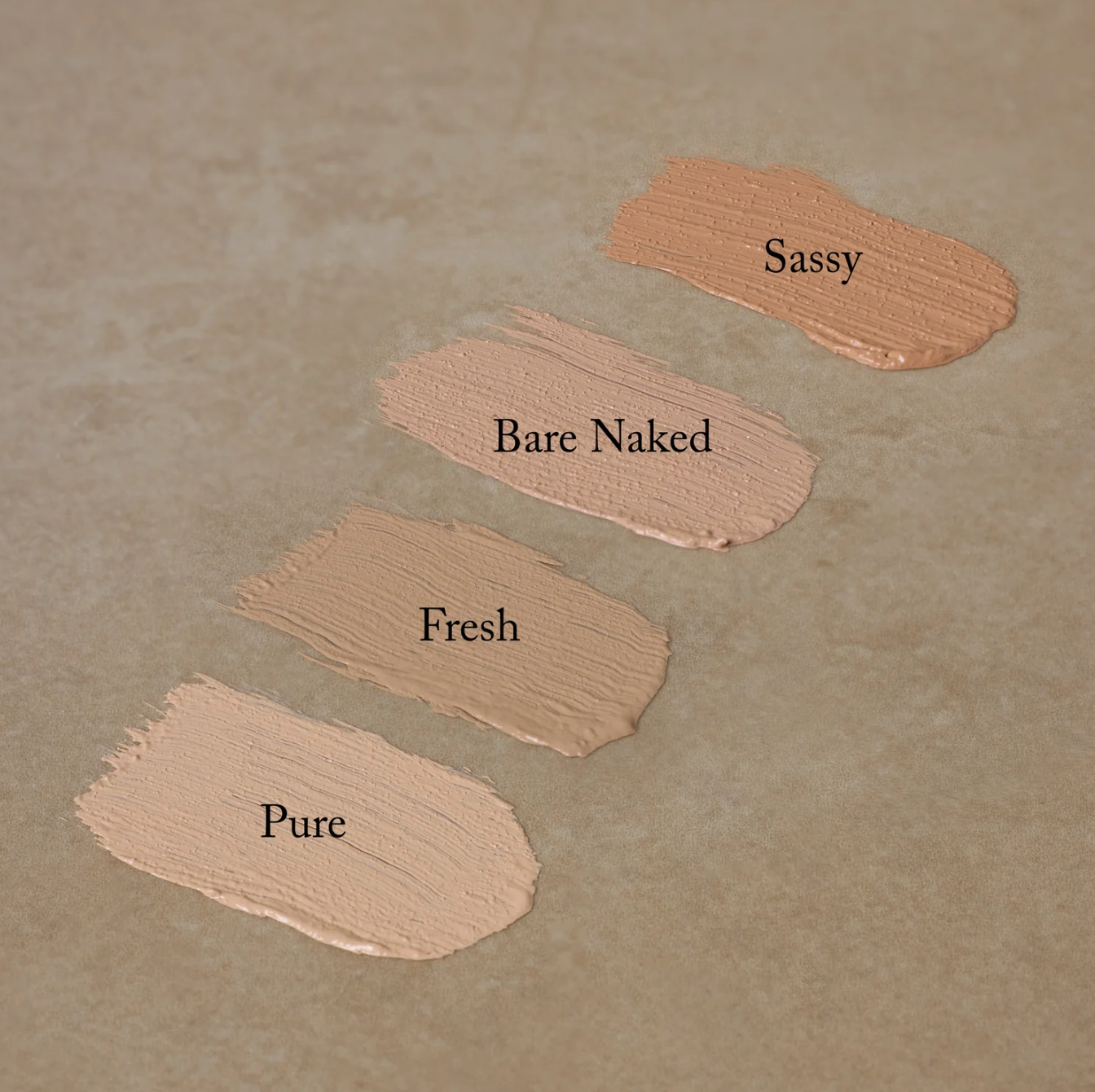 Two compact concealers with black lids, one open showing the product and the other closed, with the brand name 'Toups' visible on the packaging.