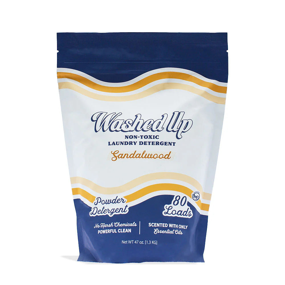 White and navy laundry detergent bag labeled "Washed Up, Sandalwood." Claims non-toxic and scented with essential oils; enough for 80 loads.