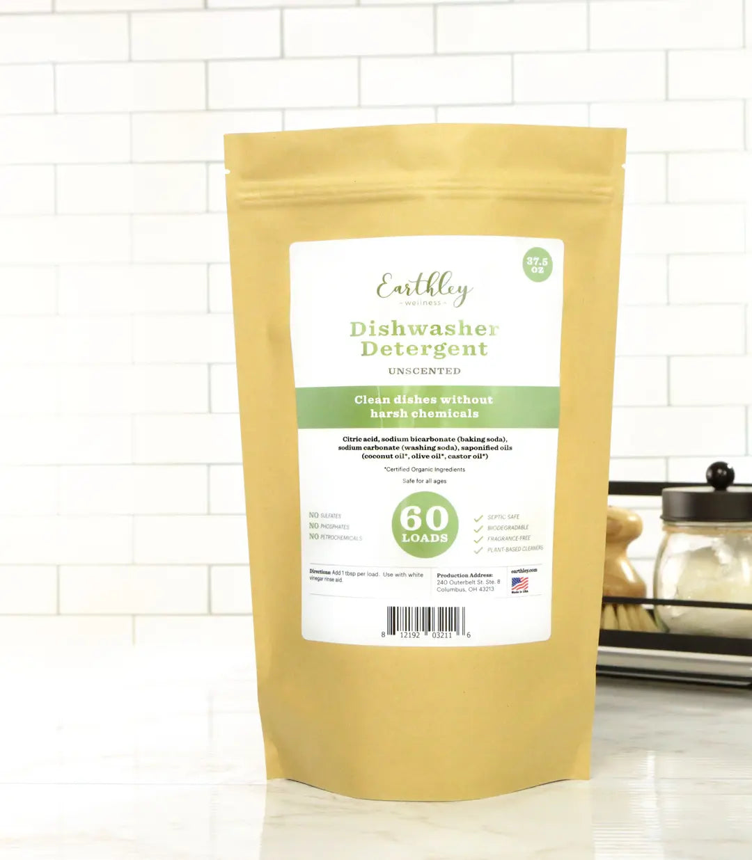 Earthly Dishwasher Detergent package on a white tiled kitchen counter