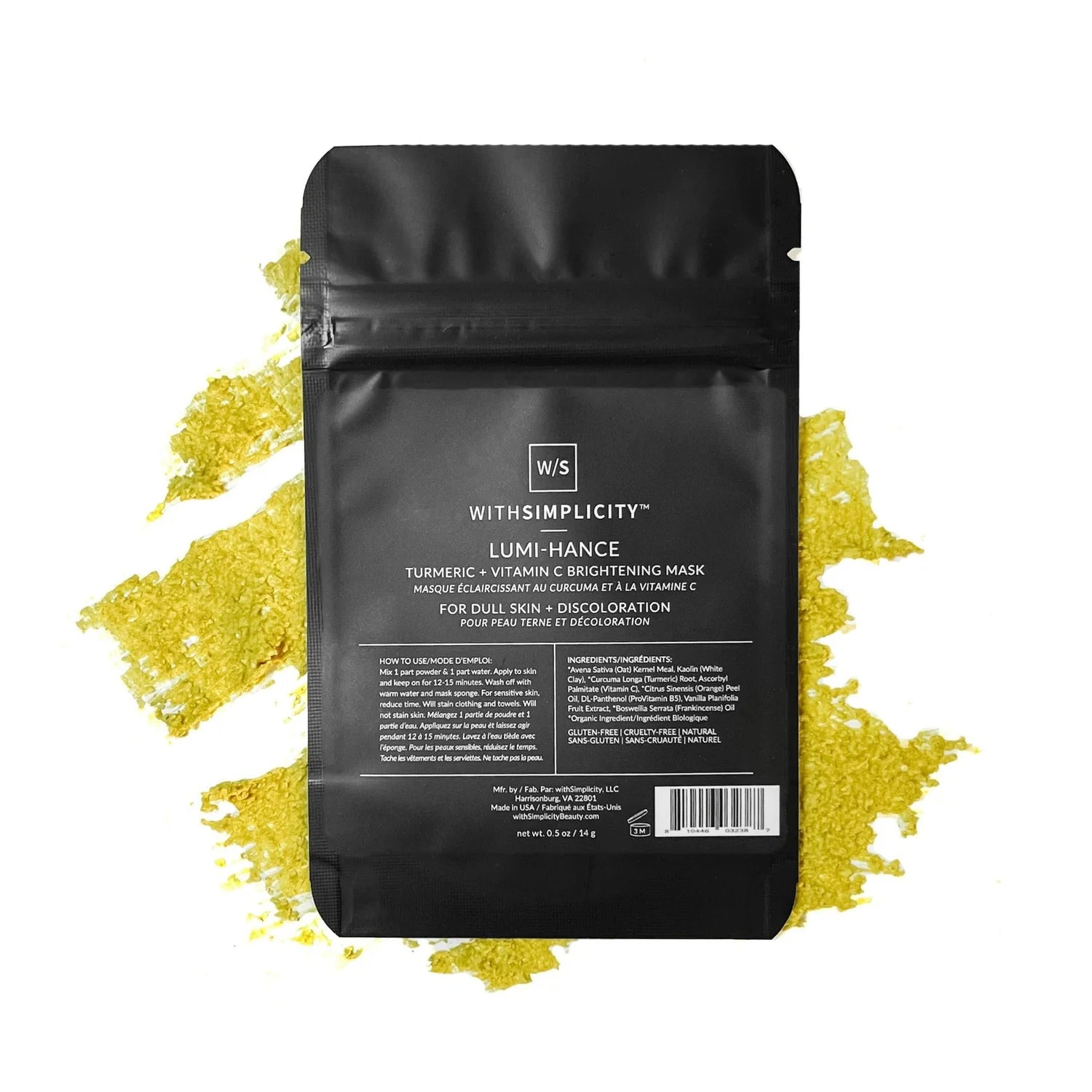 Black packaging of a turmeric and vitamin C brightening mask with yellow powder on a white background