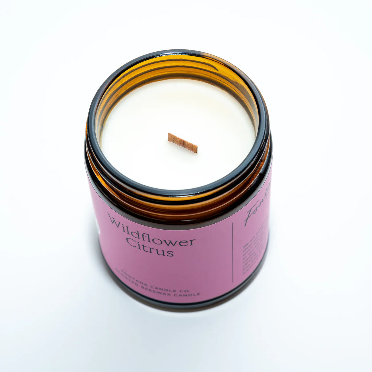 Wildflower citrus Candle with purple label on white background