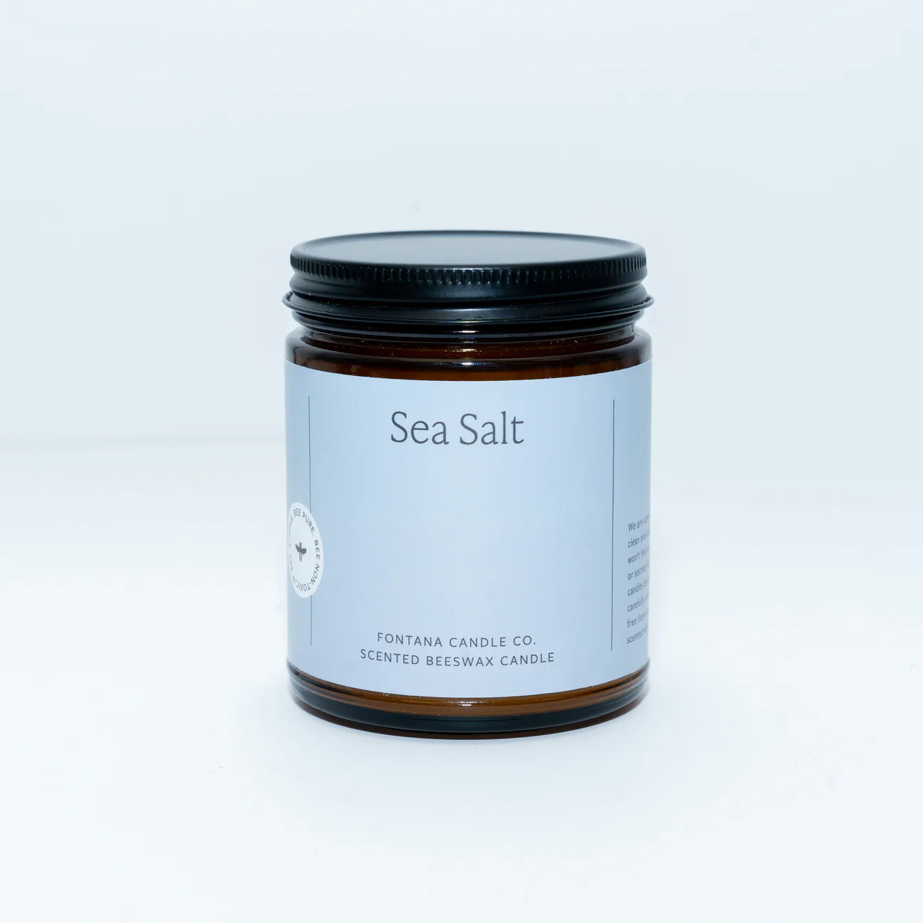 Candle jar labeled 'Sea Salt' on a plain background
