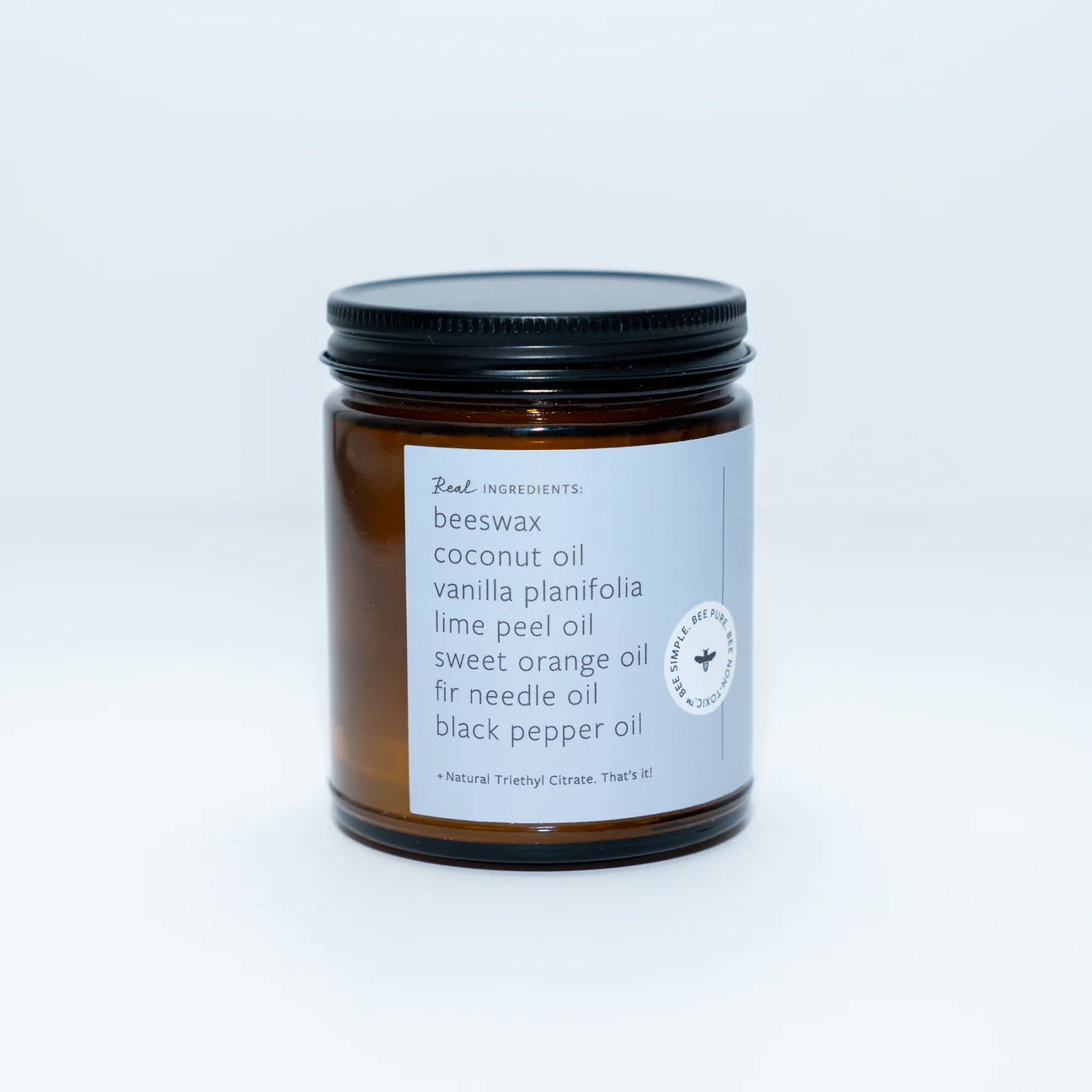 beeswax coconut oil Candle jar with label on a plain background