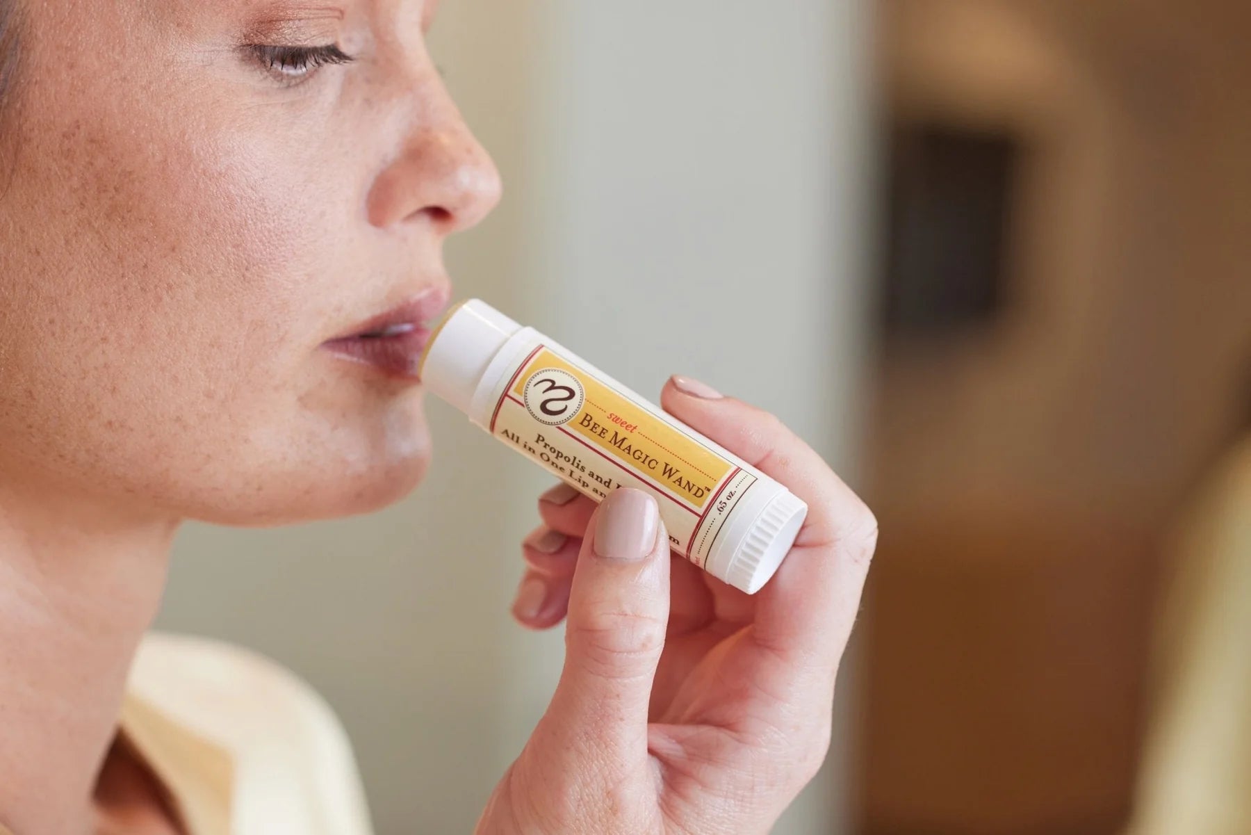 Woman applying sweet bee magic wand 