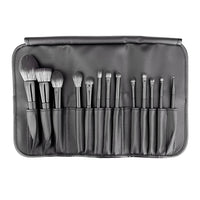 Set of makeup brushes in a black case on a white background