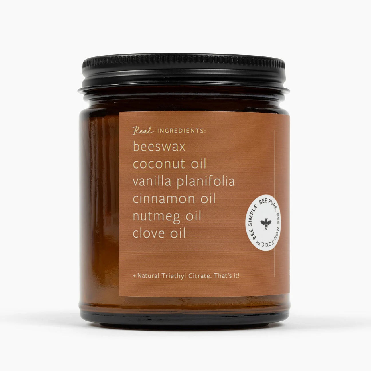 Candle jar with a brown label listing ingredients on a white background